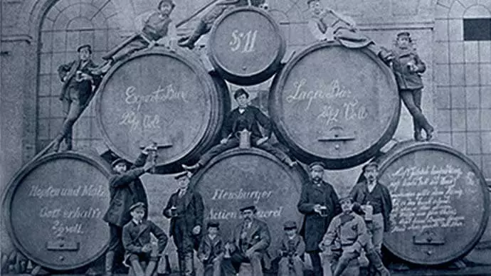 Historic picture with stacked wooden barrels.
