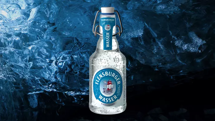 Flensburg Wasser swing top bottle, in the background a glacier cave.